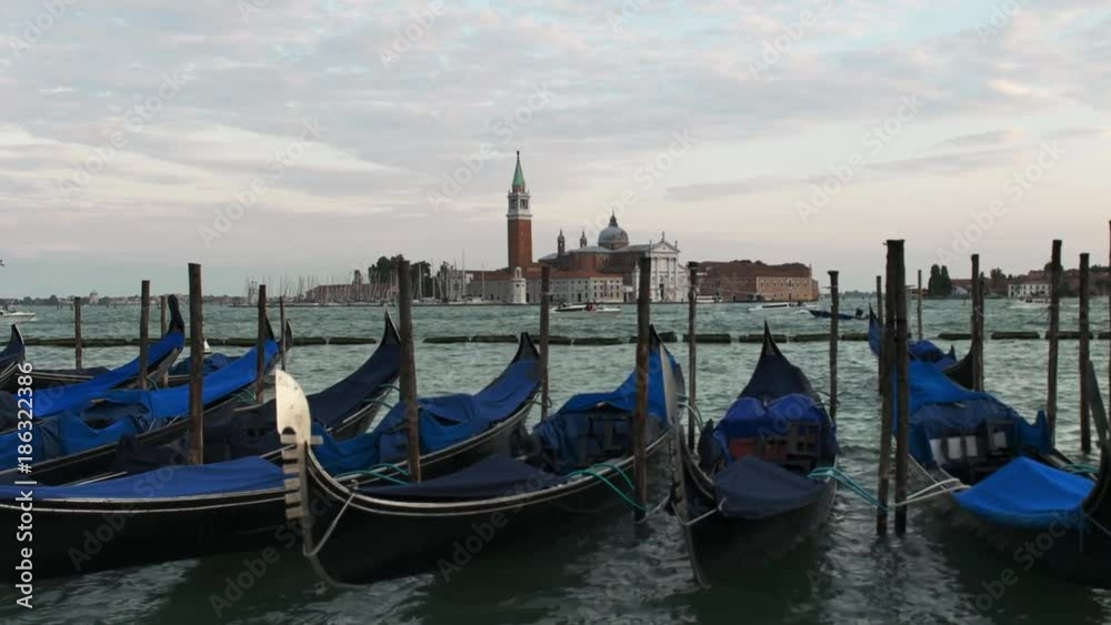 gondolas tied up at piazza san marco with the church of san giorgio maggiore, venice in the distance gondolas tied up at piazza san marco with the church of san giorgio maggiore, venice in the distance