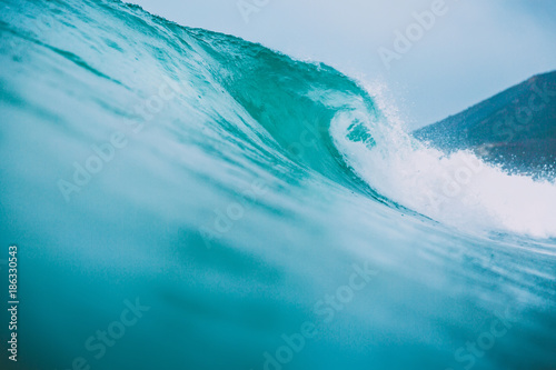Blue surfing wave breaks in the ocean