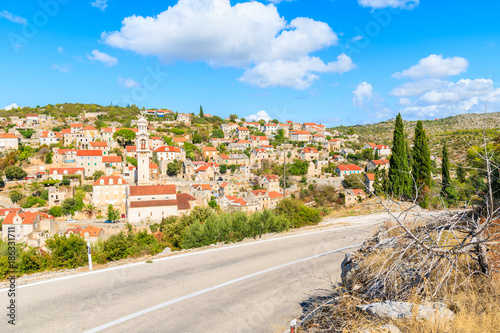 Road to Lozisca village with colorful houses and church, Brac island, Croatia photo