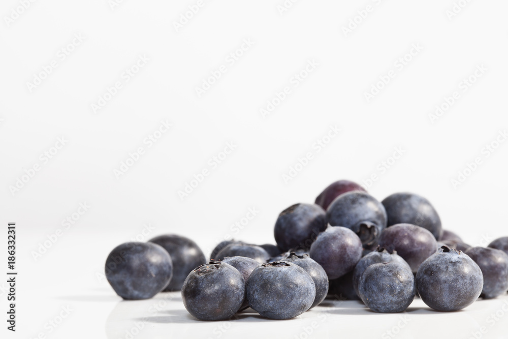 Macro photo of blueberries on white background. Shallow depth of field. Macro photo of blueberries on white background. Shallow depth of field.