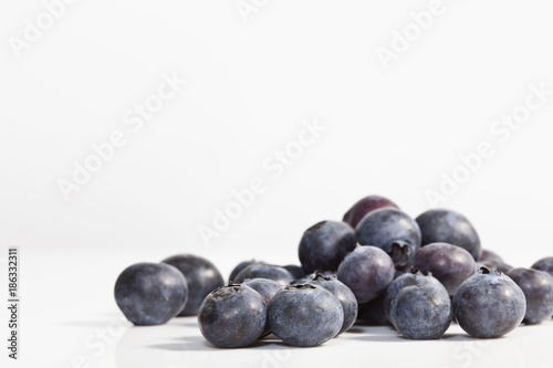 Macro photo of blueberries on white background. Shallow depth of field.