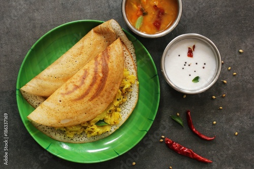 Dosa - South Indian Breakfast crepes served with chutney and sambar, top view photo