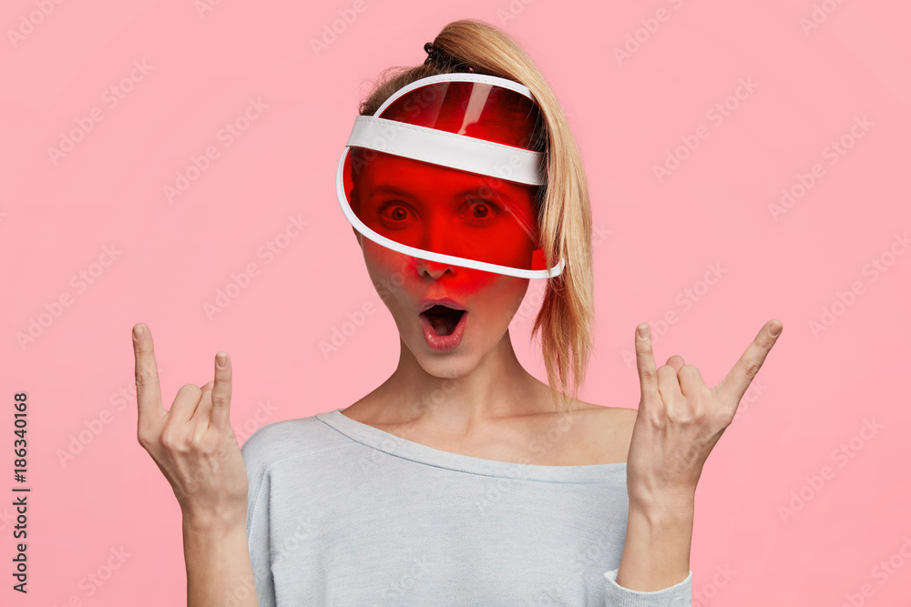 Indoor shot of amazed beautiful woman wears fashionable hat, gestures, feels herself cool, opens mouth in excitement, says: Wow, how great it is! Stylish young female isolated over pink wall Indoor shot of amazed beautiful woman wears fashionable hat, gestures, feels herself cool, opens mouth in excitement, says: Wow, how great it is! Stylish young female isolated over pink wall