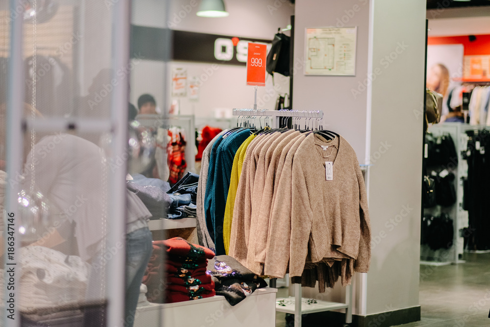 Shop hanger with sweaters in fashion store Shop hanger with sweaters in fashion store