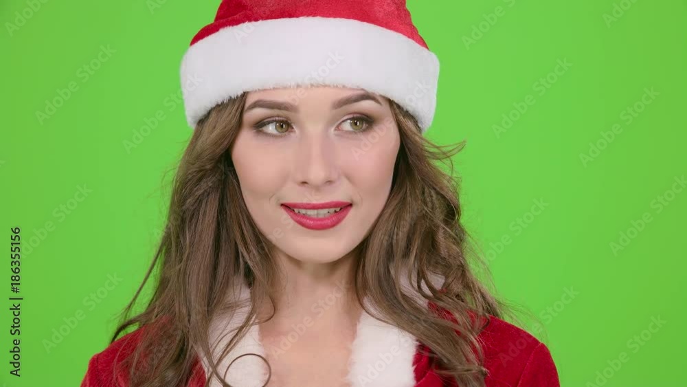 Girl in the red suit of the snow maiden scolds and points her finger a little more quietly. Green screen. Close up. Slow motion