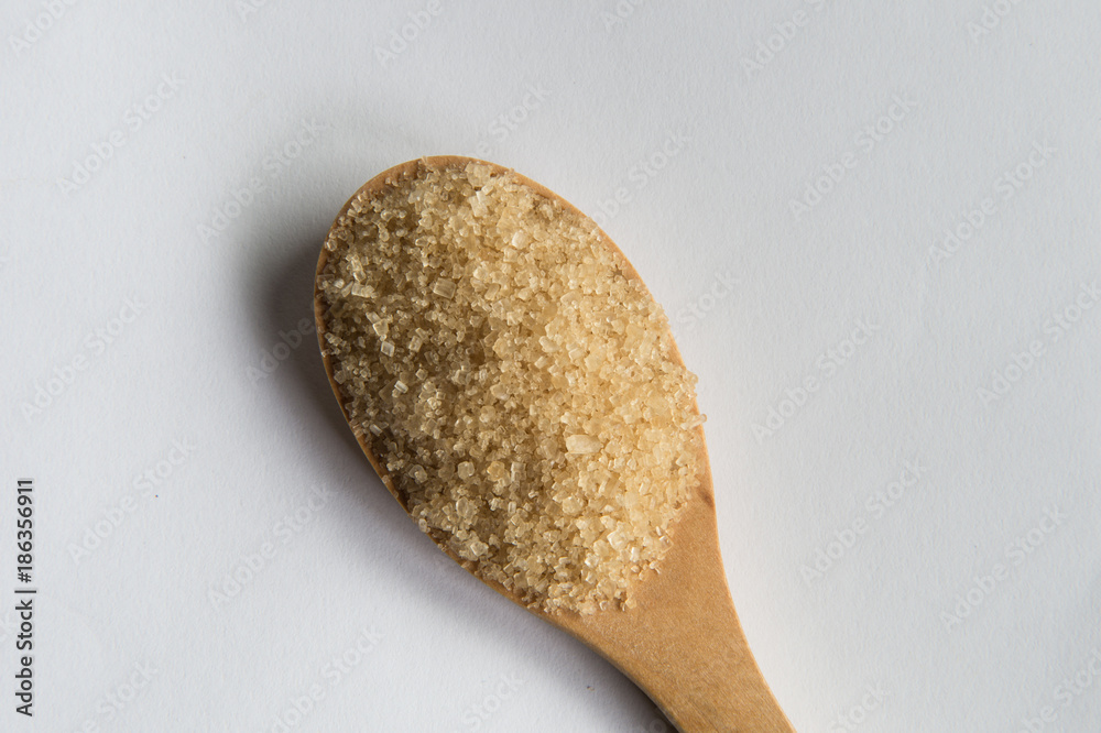 brown sugar heap and wooden spoon brown sugar heap and wooden spoon