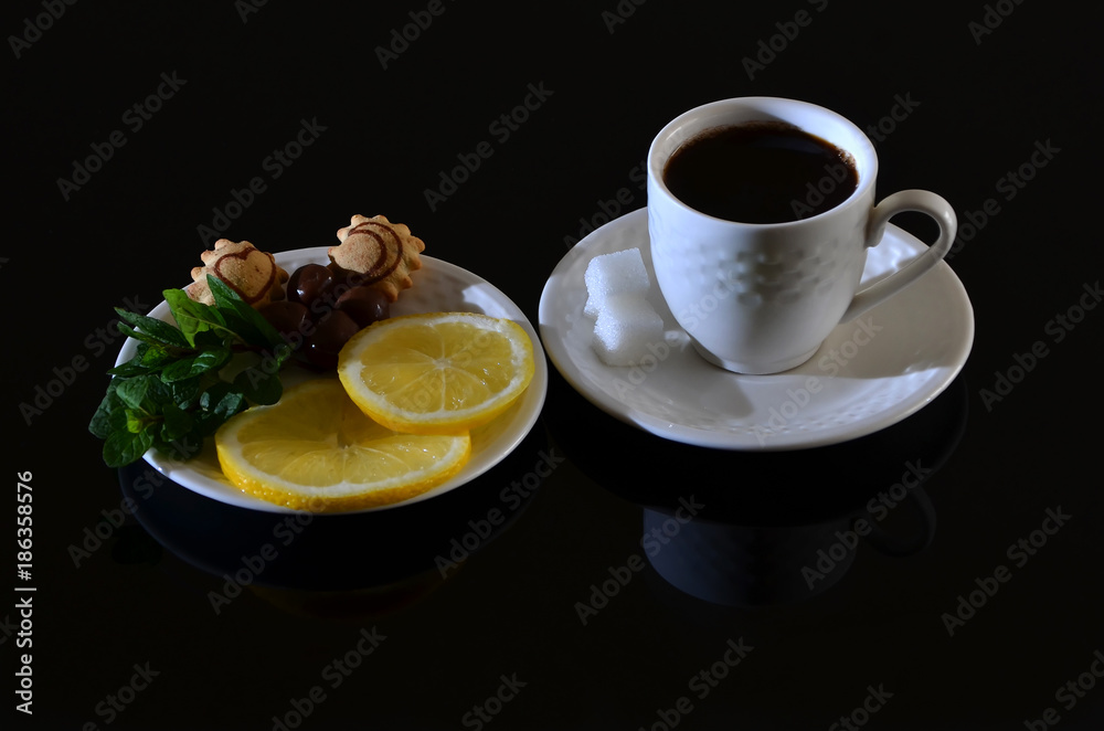 White turkish cup of coffee with sugar, orange on black table White turkish cup of coffee with sugar, orange on black table