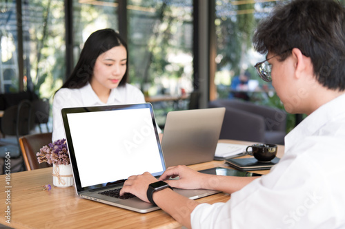 student using computer for learning leasson online at cafe. startup man & woman working with laptop at office.  young entrepreneur analyze financial data at workplace. business, education concept © 88studio