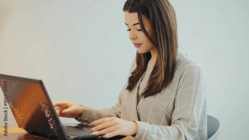 Woman blogger working in cafe using a laptop Woman blogger working in cafe using a laptop