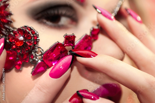 Young beautiful girl with red rose make-up and manicure closeup.