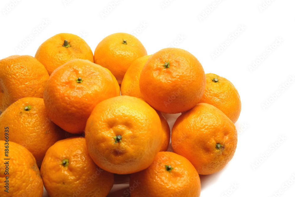 Heap of ripe orange tangerines lies in large numbers isolated on white background closeup Heap of ripe orange tangerines lies in large numbers isolated on white background closeup