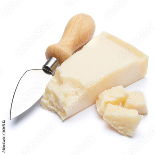 pieces of Parmesan cheese and knife on white background
