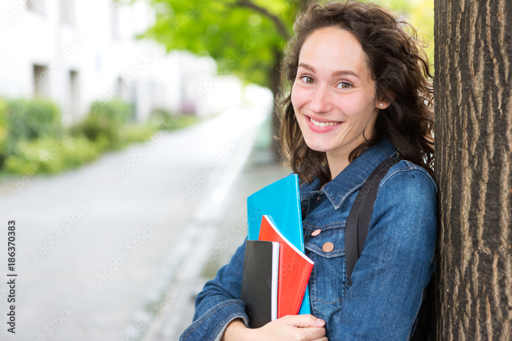 Portrait of a young student with backpack going to school and holding notebook - Back to school Portrait of a young student with backpack going to school and holding notebook - Back to school