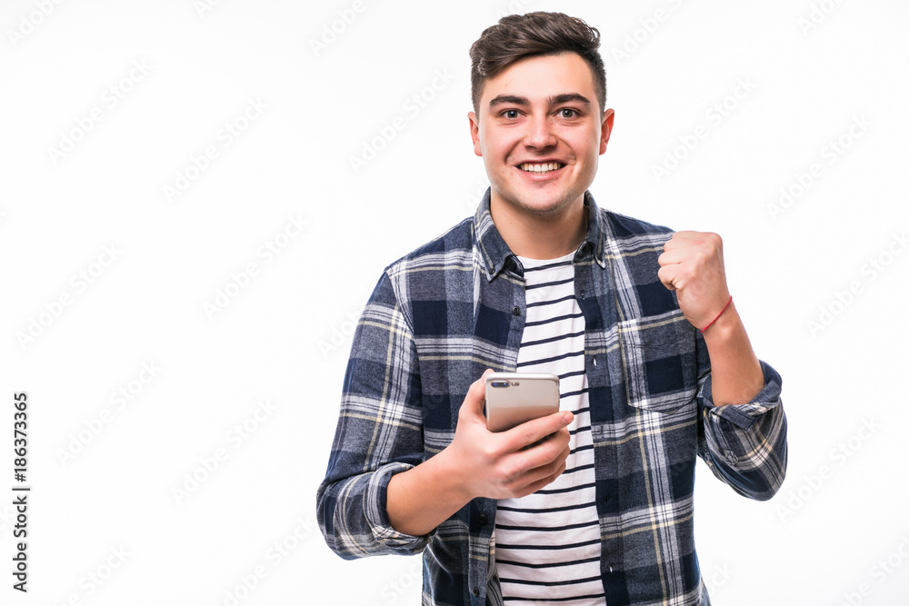 Young ecxited and happy man with phone in hand smile on camera on white background Young ecxited and happy man with phone in hand smile on camera on white background