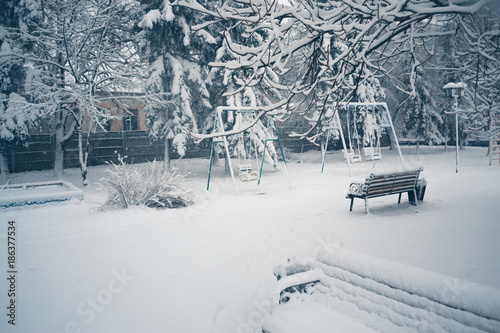 Snowy winter day on a playground in the snow. photo