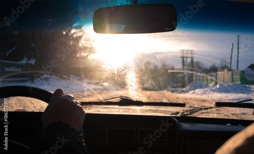 View from car window in winter snowy evening. Concept travel.