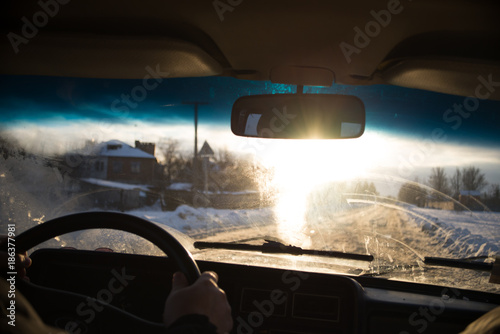 View from car window in winter snowy evening. Concept travel.