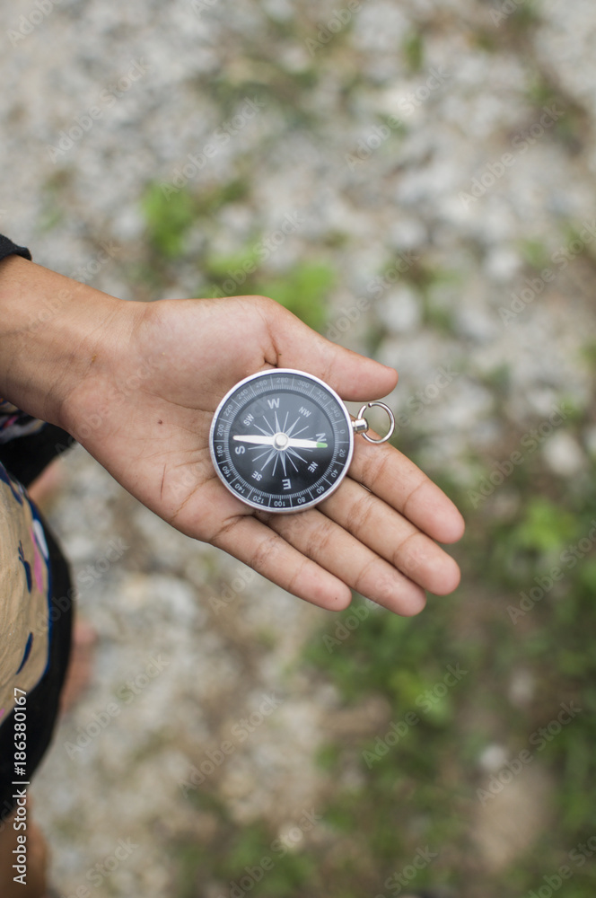 Compass in the hand against mountain. Adventure end travel background. Compass in the hand against mountain. Adventure end travel background.