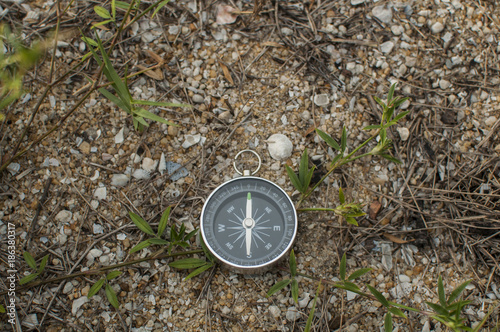 Compass in the hand against mountain. Adventure end travel background.