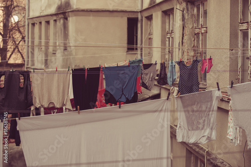 Clothes hang on clothesline at house backyard © Volodymyr