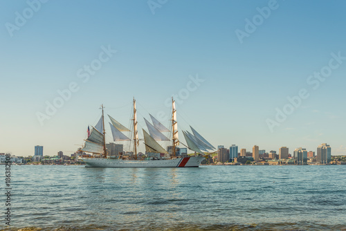 Tall ship in the harbour with Halifax downtown skyline on a sunny day