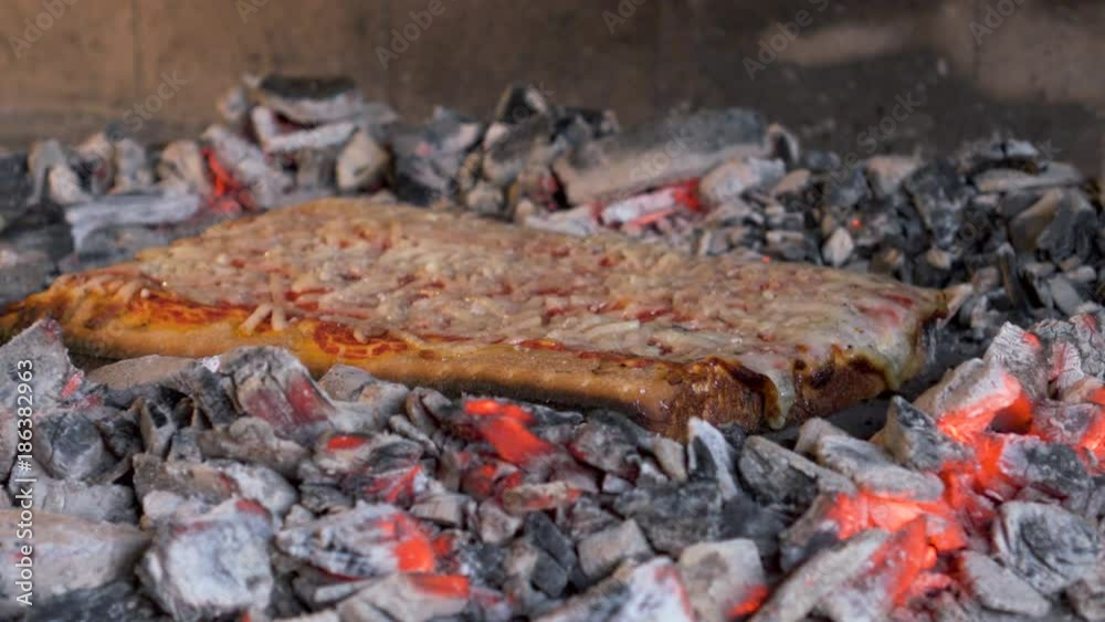 Hot Home Made Pizza Margarita cooked on glowing charcoals in Oven.Close-Up. Italy Hot Home Made Pizza Margarita cooked on glowing charcoals in Oven.Close-Up. Italy