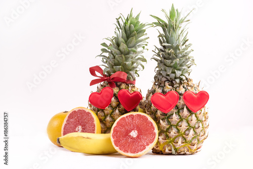 Fototapeta Naklejka Na Ścianę i Meble -  Two Ripe Pineapples on White Background Ripe Juicy Tropical Fruits Grapefruit St Valentines Day Food Concept Copy space