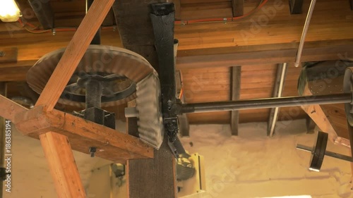 wooden gears turning in a working windmill at oatlands in tasmania, australia photo