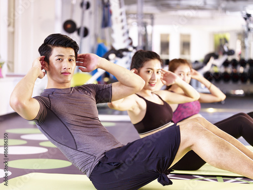 Photography group of young asian people exercising in gym