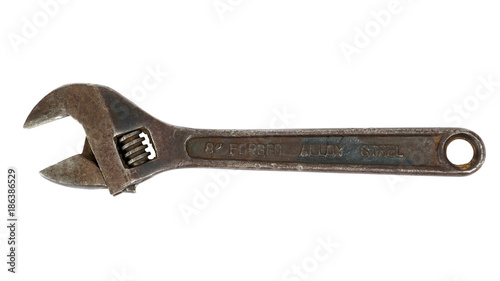 Rusty adjustable wrench on white background © mkos83