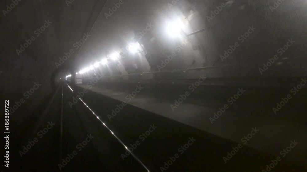 Train riding fast in a dark underground tunnel in the modern city