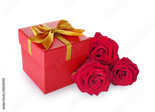 Red classic gift box with golden satin bow and bouquet of roses