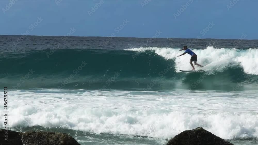 slow motion shot of a surfer performing several re entries on a wave at australia's gold coast, originally recorded at 120fps slow motion shot of a surfer performing several re entries on a wave at australia's gold coast, originally recorded at 120fps