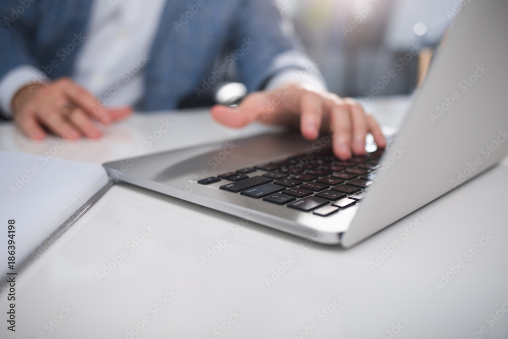 Work time. Close up of male hands using laptop at work. Focus on notebook Work time. Close up of male hands using laptop at work. Focus on notebook