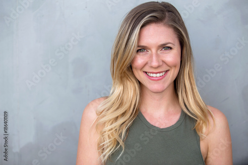 Fototapeta Gorgeous headshot of young bright cheerful sincere smiling caucasian blond femal