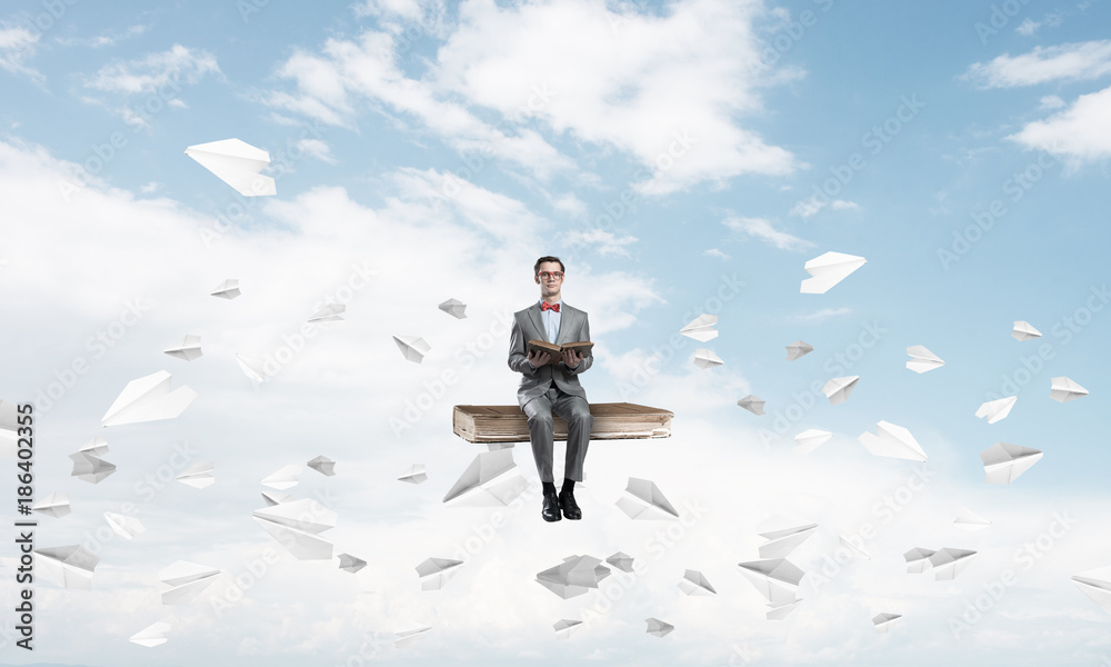 Young businessman or student in blue sky studying the science Young businessman or student in blue sky studying the science
