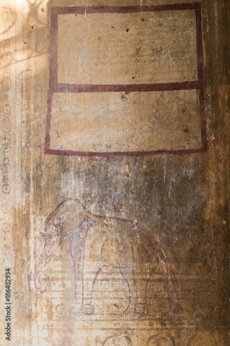 Old, aged and damaged wall with paintings and writings at the Htilominlo Temple in Bagan, Myanmar (Burma).