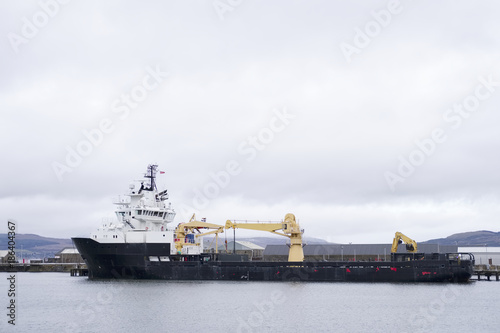 One large ship carrier at dockyard waiting for containers to be loaded