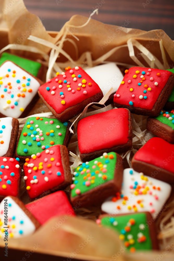 Open box Christmas different colour cookies on a old wooden table.Closeup