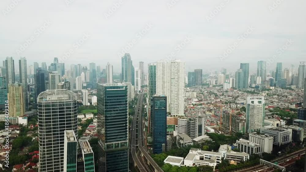 JAKARTA - Indonesia. December 22, 2017: Beautiful aerial shot of Jakarta City skyline from a drone flying above central business district. Shot in 4k resolution JAKARTA - Indonesia. December 22, 2017: Beautiful aerial shot of Jakarta City skyline from a drone flying above central business district. Shot in 4k resolution