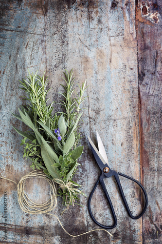 Bouquet Garni Herbs with String and Scissors on Grunge Timber Background