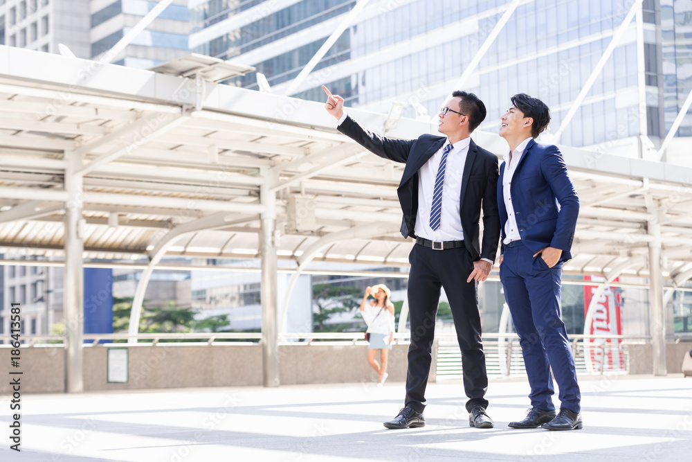 Asian two businessmen happy are working in city Asian two businessmen happy are working in city