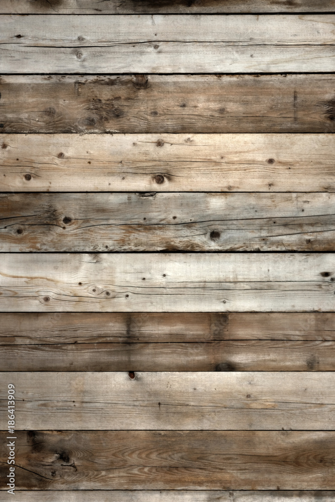 Fototapeta premium Old dark weathered distressed damaged stained grunge wood grain planked wall rustic background texture photo vertical