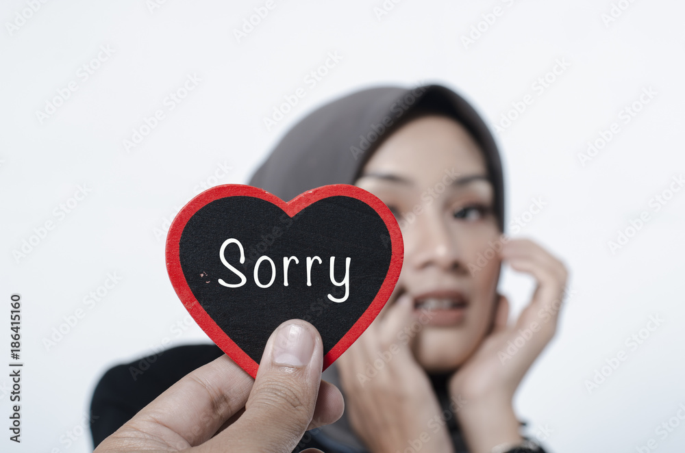conceptual image,romantic look hand holding heart made from wood with word SORRY over blurred and selective focus background conceptual image,romantic look hand holding heart made from wood with word SORRY over blurred and selective focus background