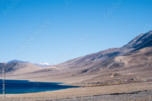 Landscape image of Pangong lake with mountains view and blue sky background