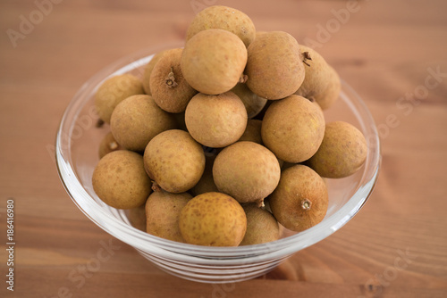 Bowl filled with an heap Dimocarpus Longan fruit