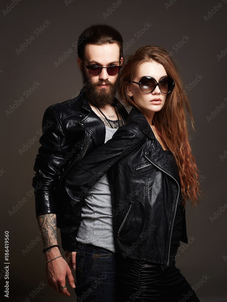 fashion beautiful couple in sunglasses and leather