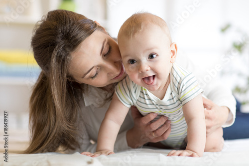 Happy baby near to mom in room