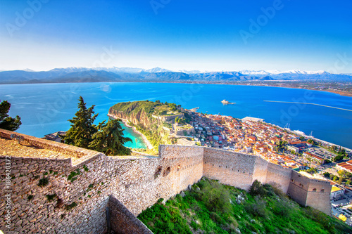 Old town of Nafplion in Greece view from above with tiled roofs, small port and bourtzi castle on the Mediterranean sea water photo