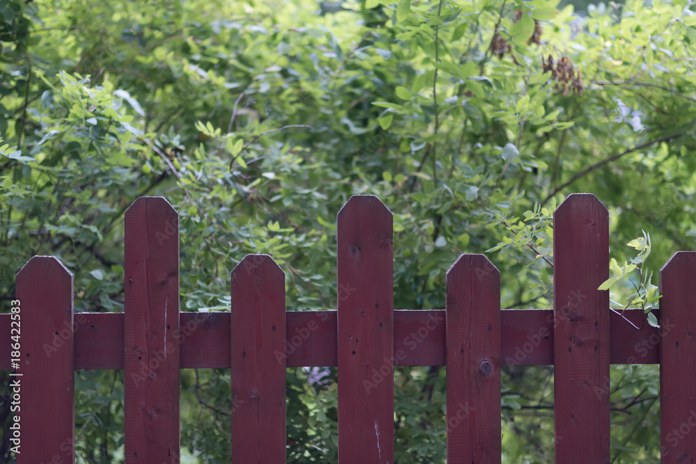 Fence made from red wooden vertical planks. Fence made from red wooden vertical planks.